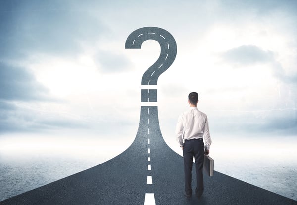 Business person looking at road with question mark sign concept